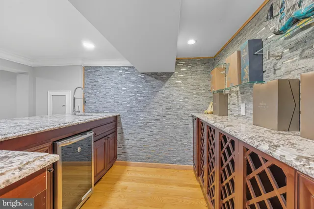 a view of a deck with wooden floor and fence next to a yard