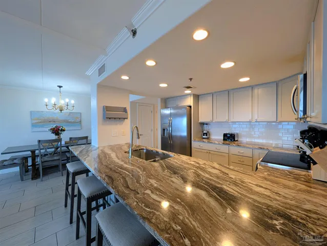 a kitchen with kitchen island granite countertop lots of counter top space and furniture