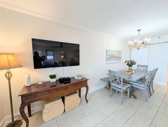 a work room with furniture and a flat screen tv