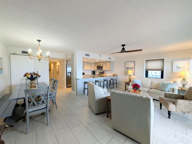 a living room with furniture and a dining room