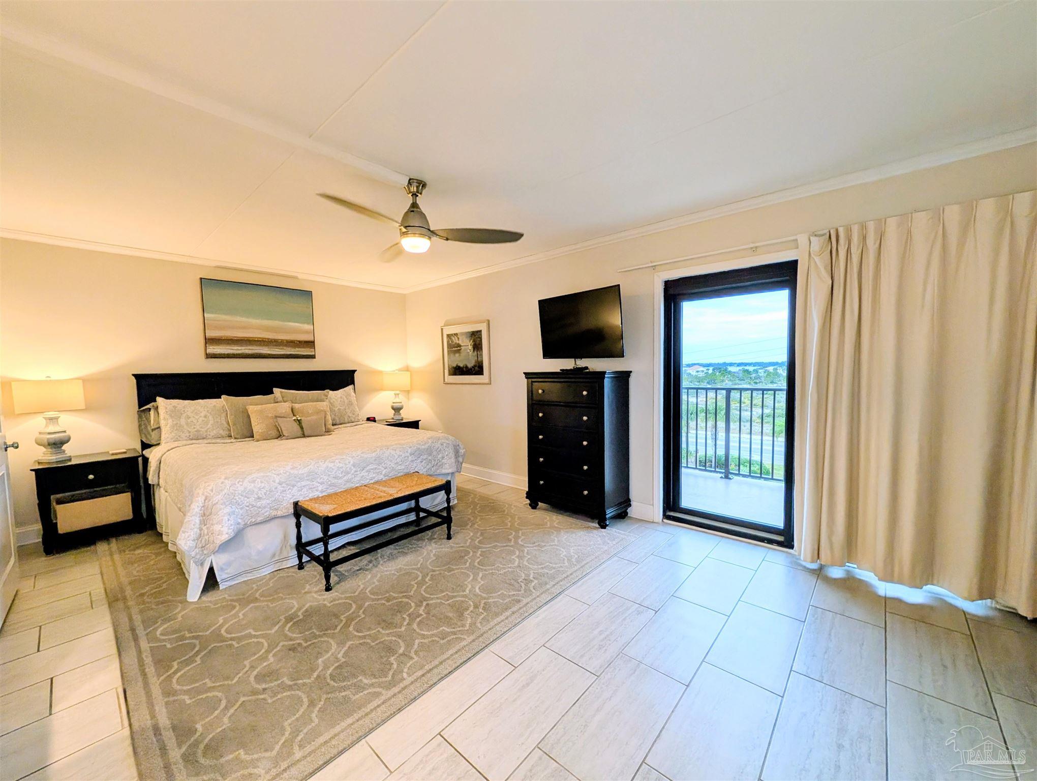 14623 Perdido Key Drive, Unit 401 Perdido Key, FL 32507 - Photo 19 of 40 a spacious bedroom with a bed and a television