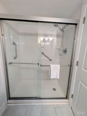 a bathroom with a glass shower door