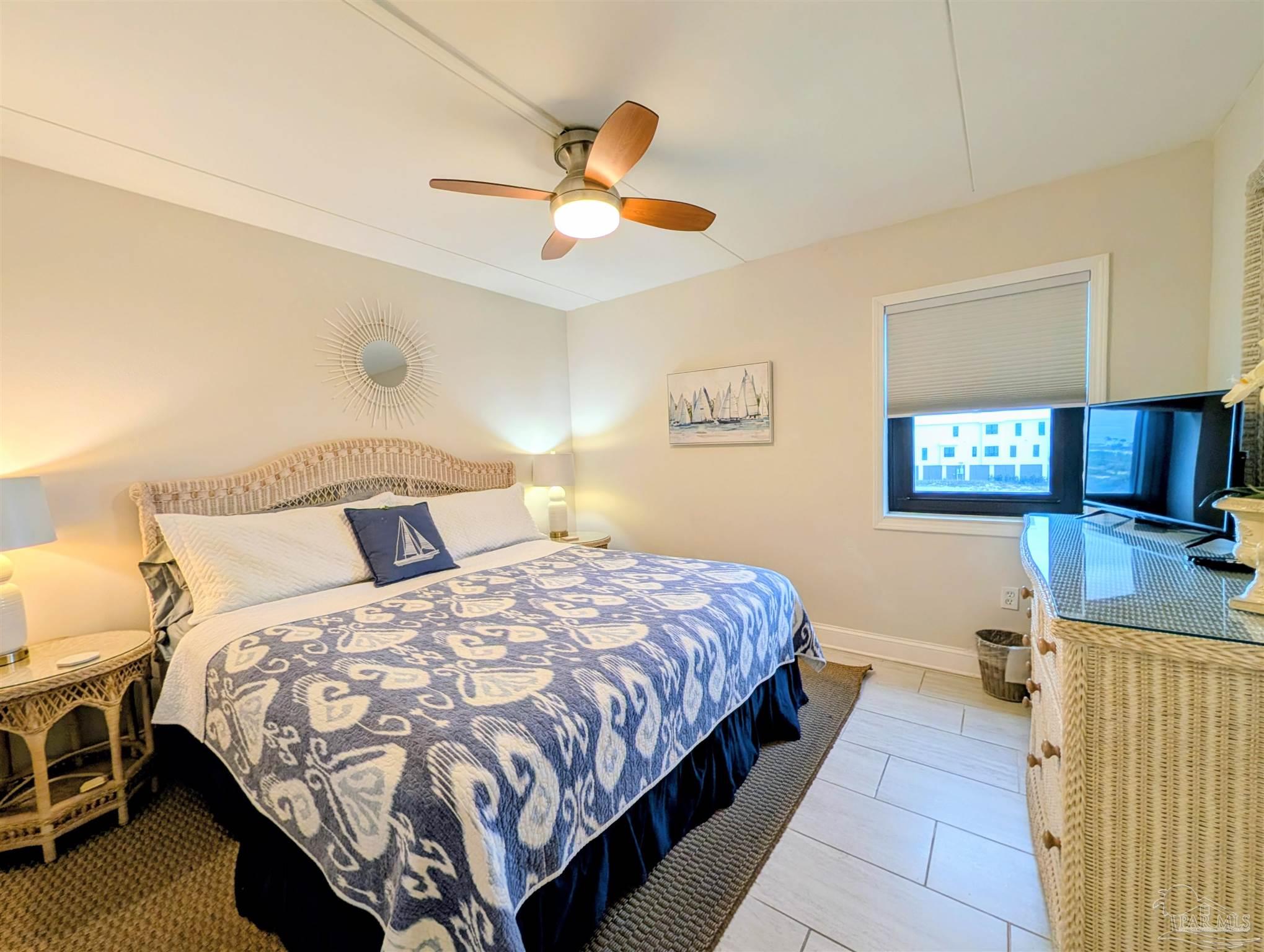 14623 Perdido Key Drive, Unit 401 Perdido Key, FL 32507 - Photo 25 of 40 a bedroom with a bed and a chandelier