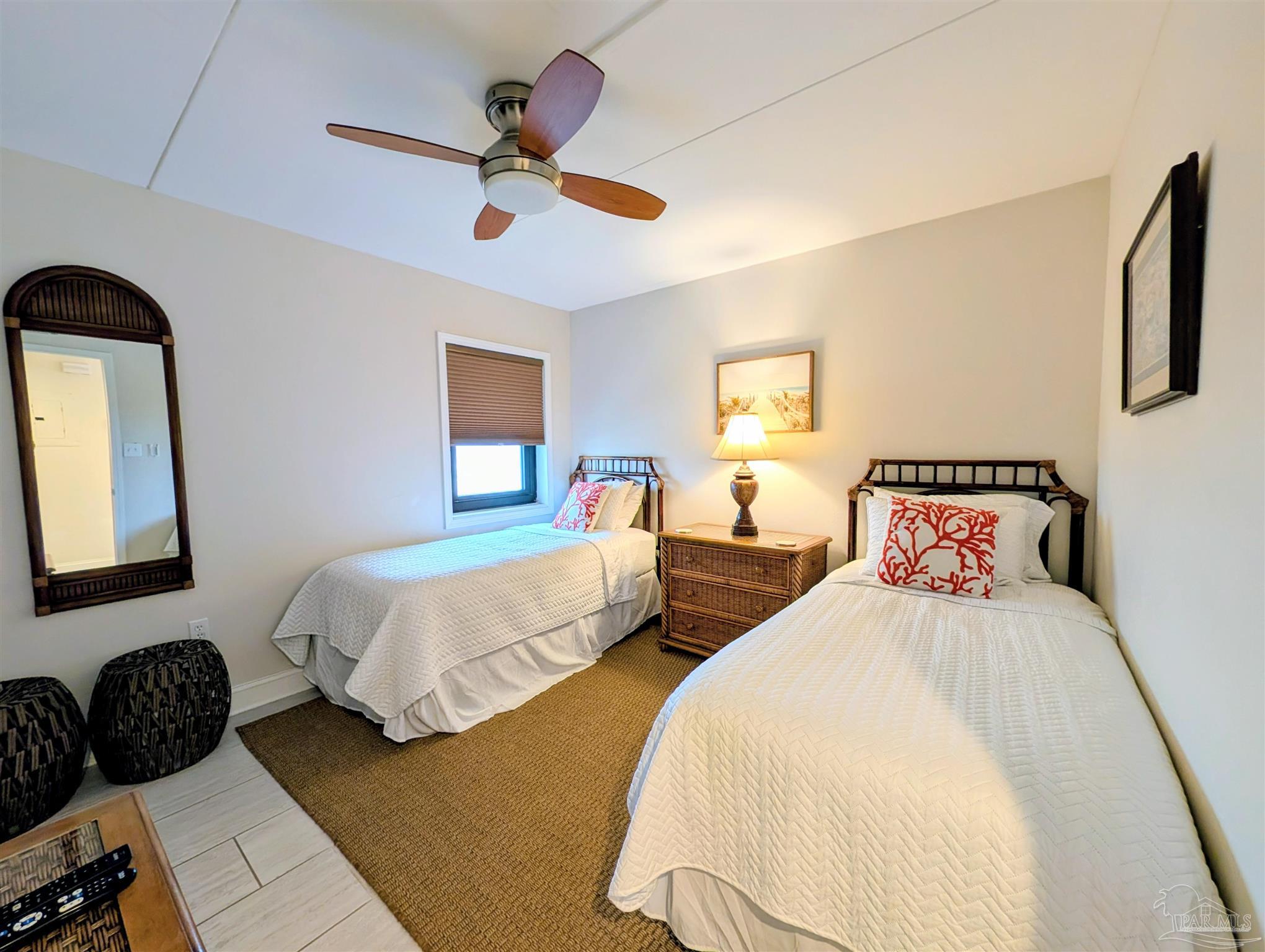 14623 Perdido Key Drive, Unit 401 Perdido Key, FL 32507 - Photo 28 of 40 a bedroom with two beds and a large mirror