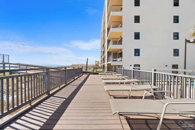 a view of a balcony with wooden floor and seating space