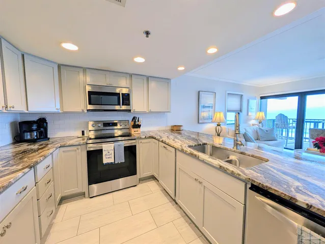 a kitchen with granite countertop a sink and appliances
