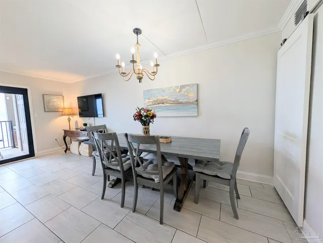 a view of a dining room with furniture and chandelier