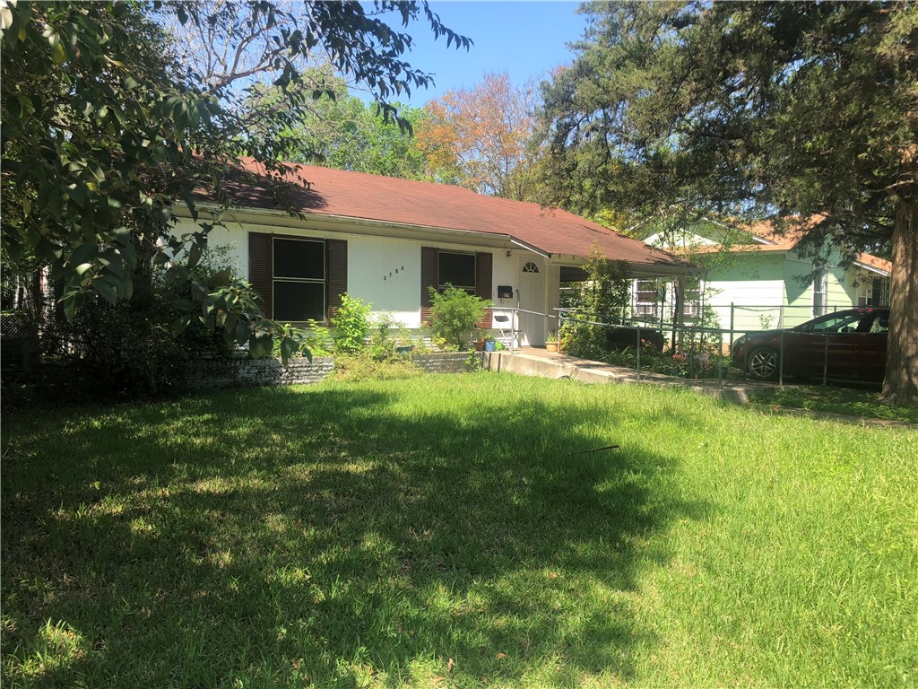 a view of a house with a yard porch and sitting area