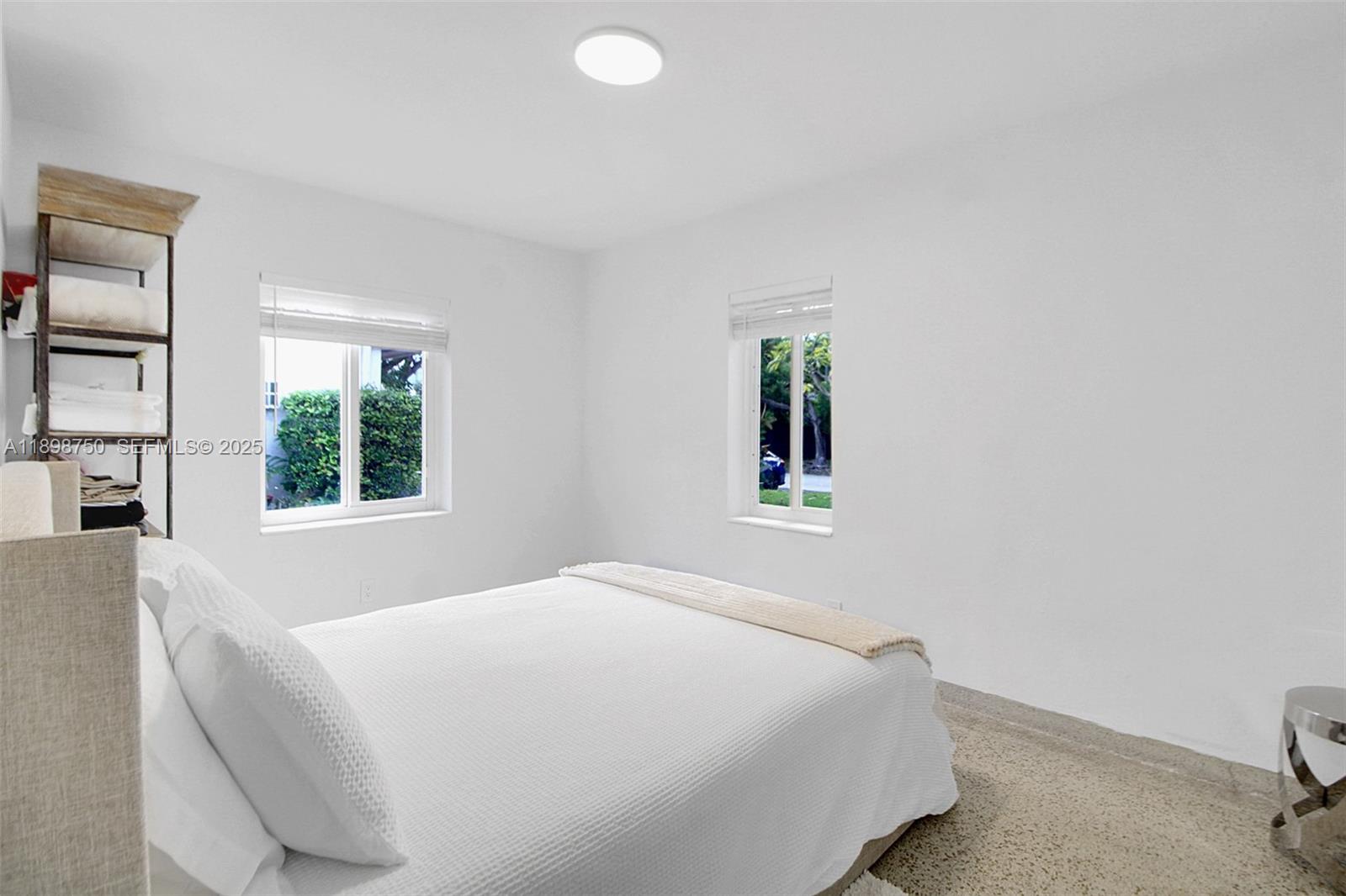 231 Northeast 43rd Street Miami, FL 33137 - Photo 13 of 35 a bedroom with a bed and a window