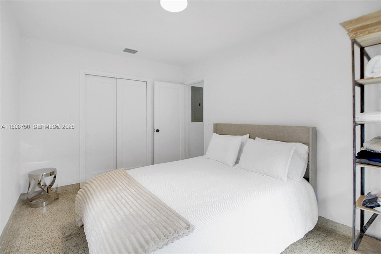 231 Northeast 43rd Street Miami, FL 33137 - Photo 14 of 35 a bedroom with a bed and a table