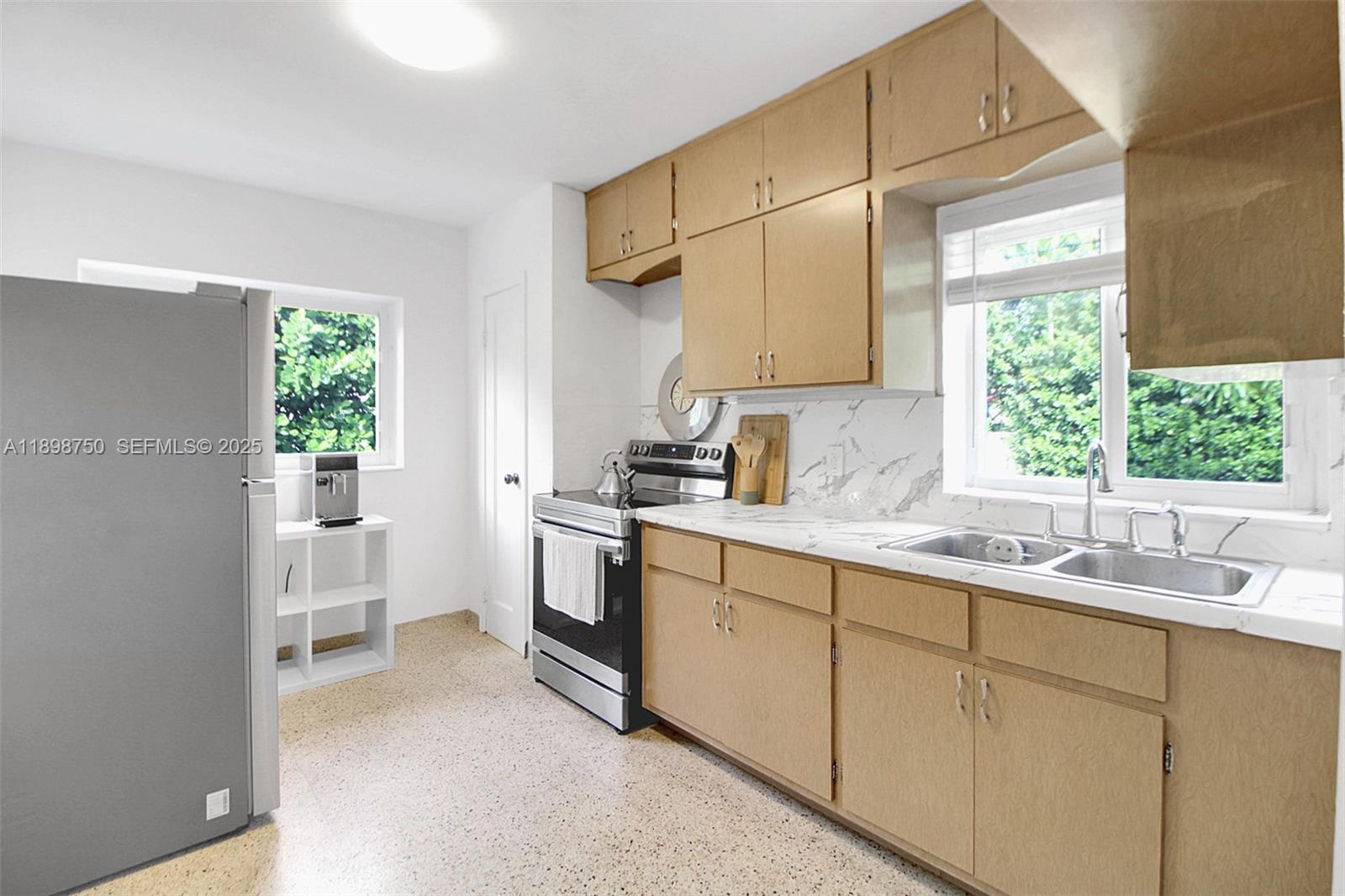 231 Northeast 43rd Street Miami, FL 33137 - Photo 19 of 35 a kitchen with a sink cabinets and window