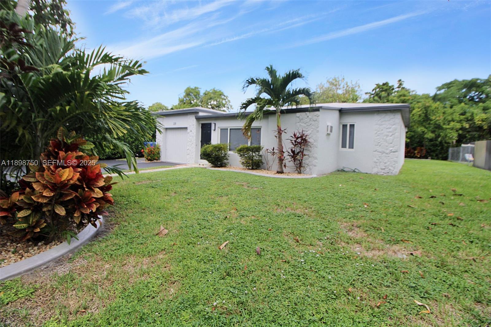 231 Northeast 43rd Street Miami, FL 33137 - Photo 26 of 35 a view of a house with a yard and a tree