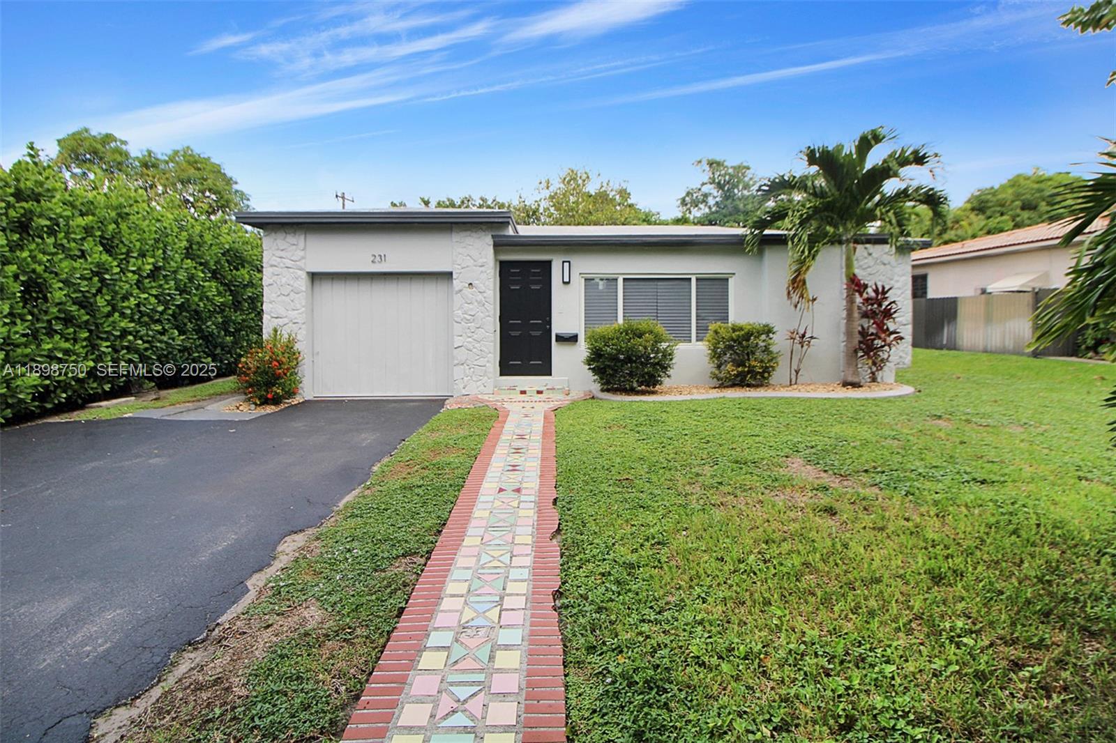 231 Northeast 43rd Street Miami, FL 33137 - Photo 27 of 35 a view of a house with a yard and potted plants