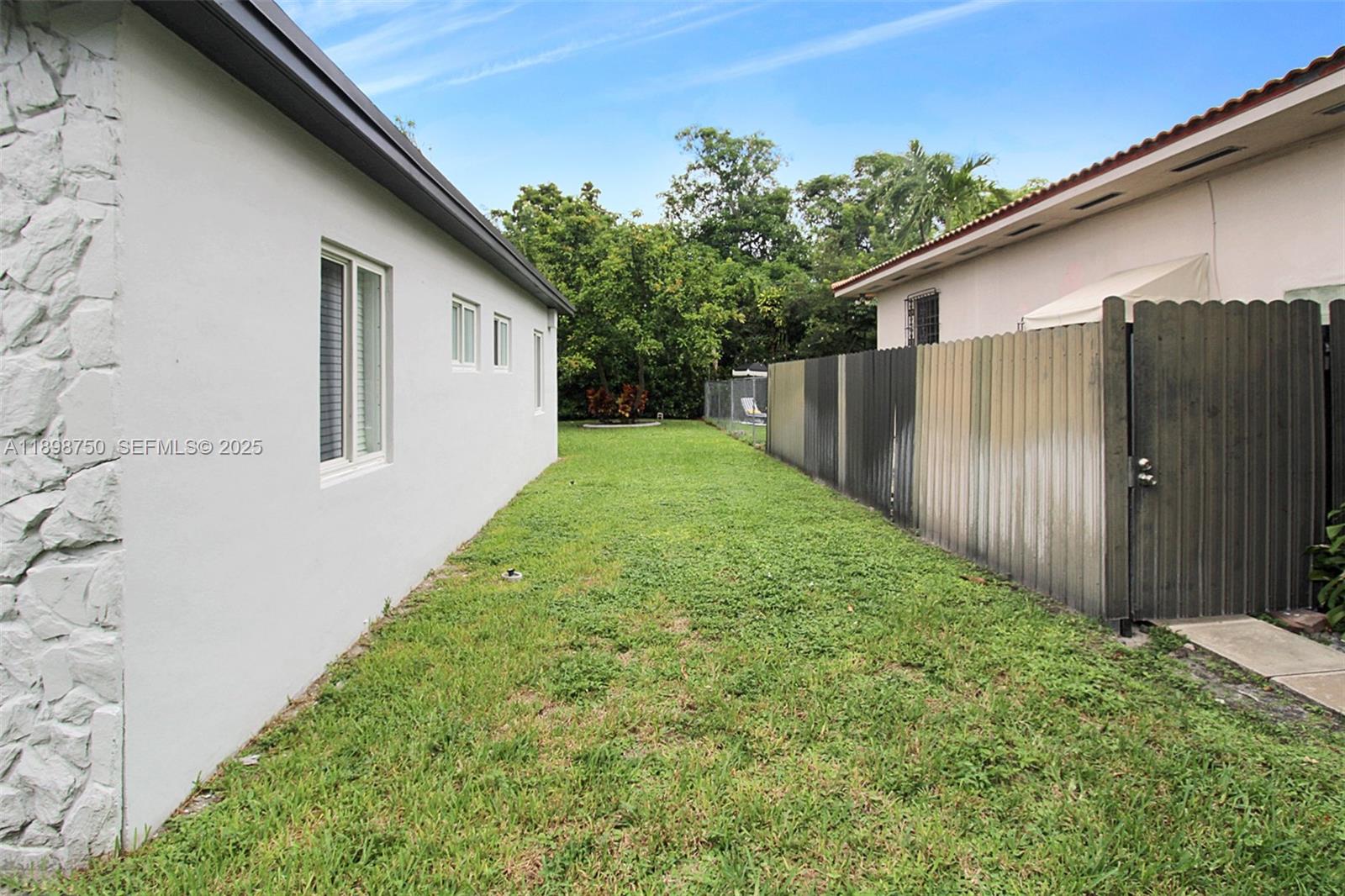 231 Northeast 43rd Street Miami, FL 33137 - Photo 32 of 35 a backyard of a house with lots of green space