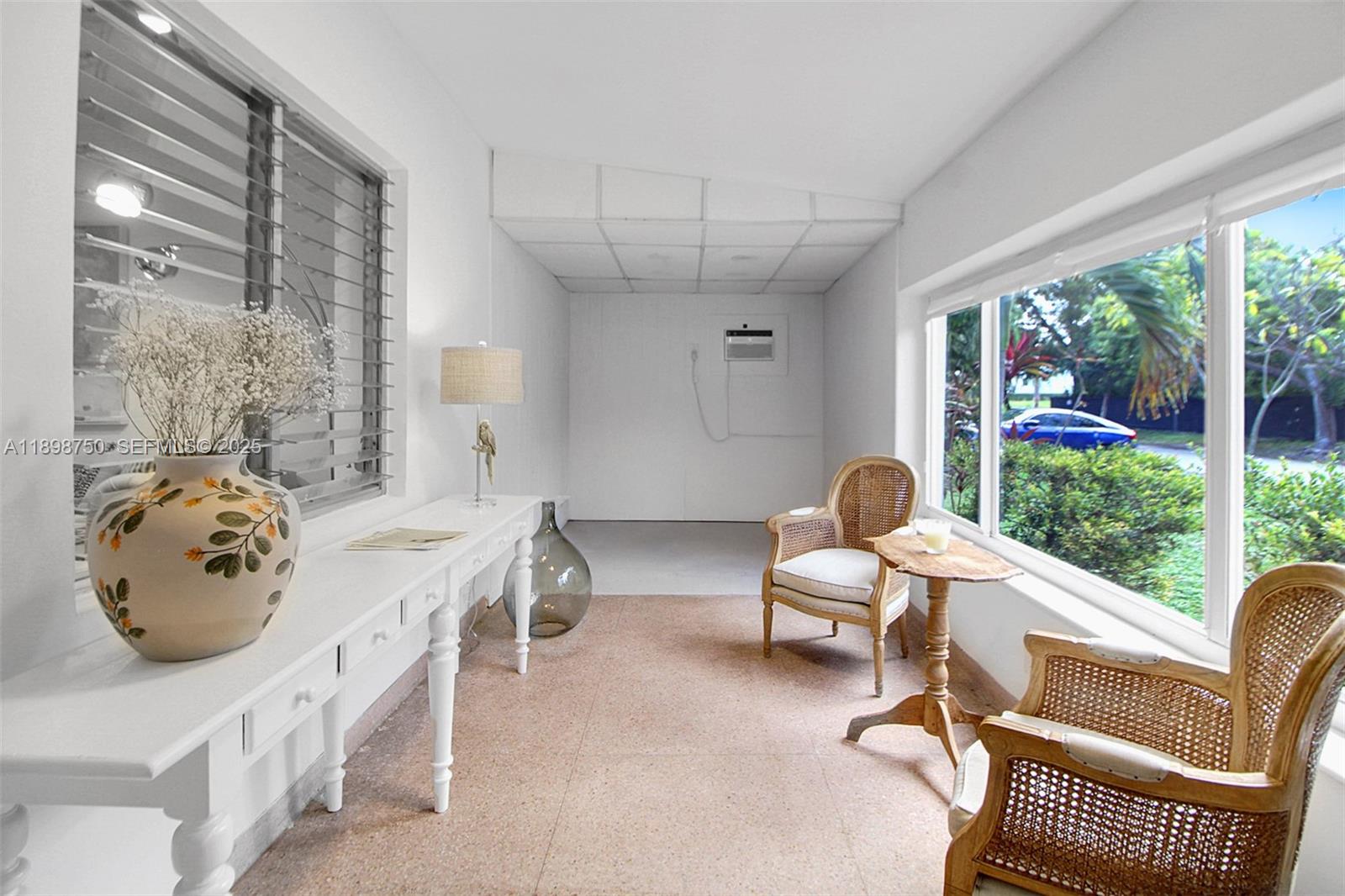 231 Northeast 43rd Street Miami, FL 33137 - Photo 4 of 35 a living room with furniture and a large window