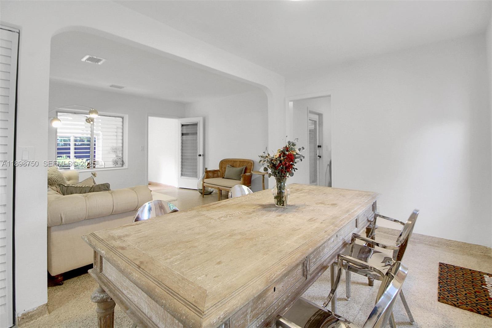 231 Northeast 43rd Street Miami, FL 33137 - Photo 6 of 35 a dining room with furniture and wooden floor
