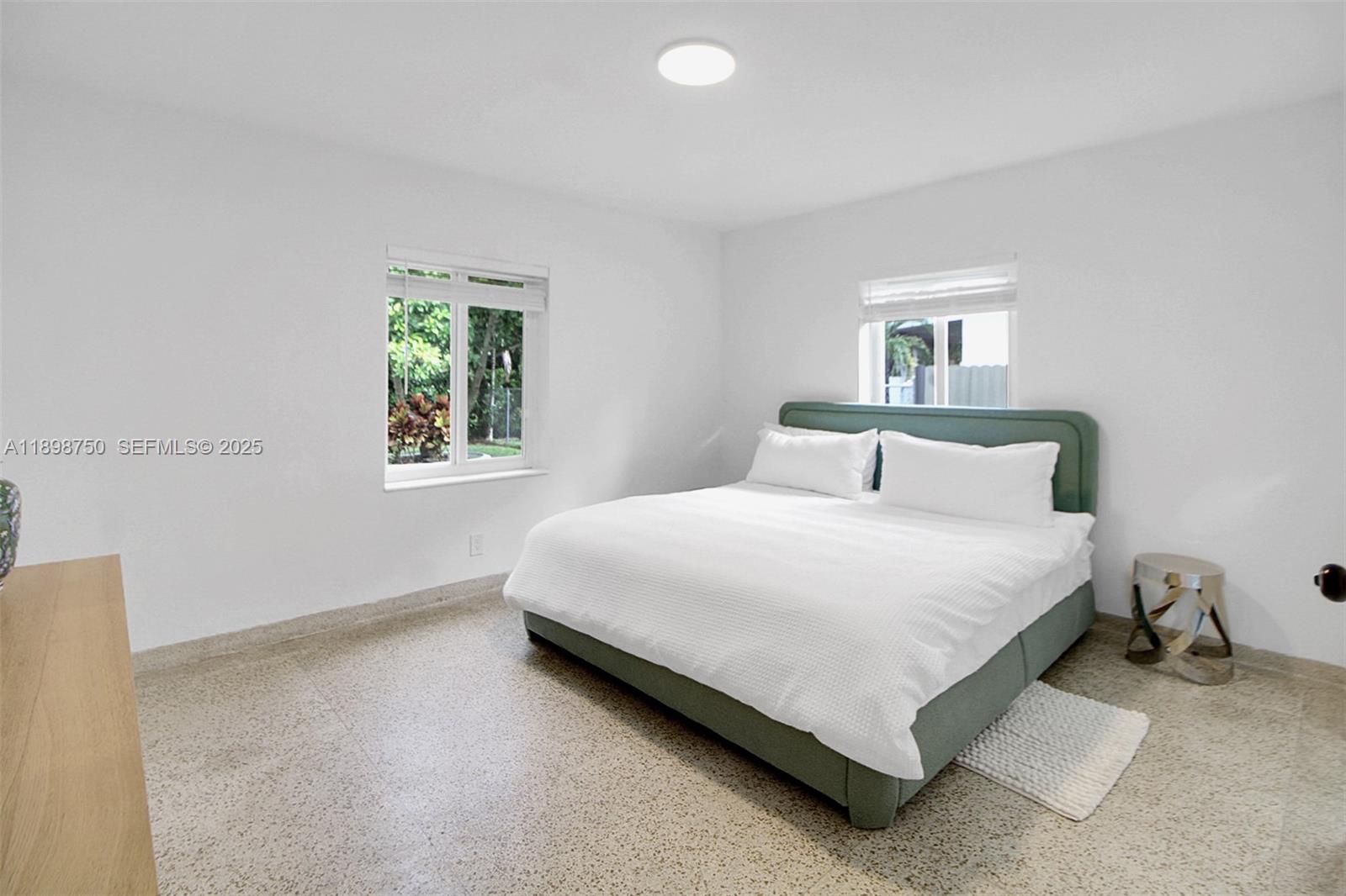 231 Northeast 43rd Street Miami, FL 33137 - Photo 9 of 35 a bedroom with a bed and a window