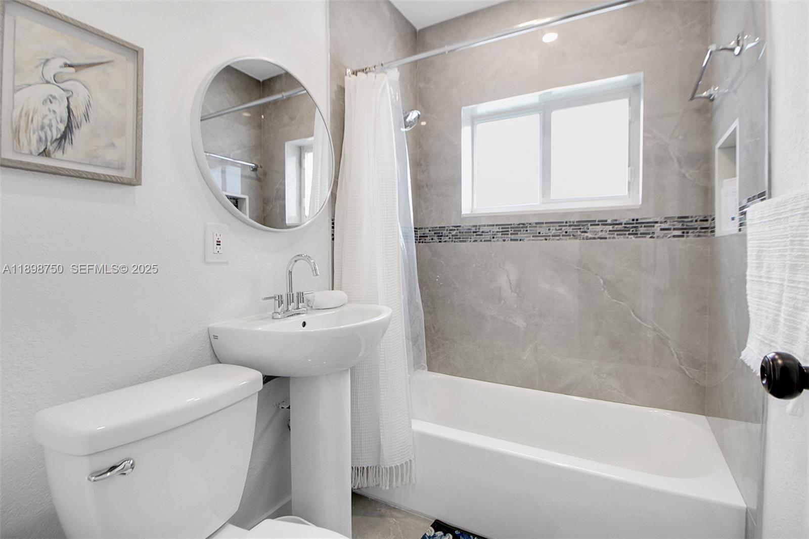 231 Northeast 43rd Street Miami, FL 33137 - Photo 10 of 35 a bathroom with a sink a toilet and a bathtub