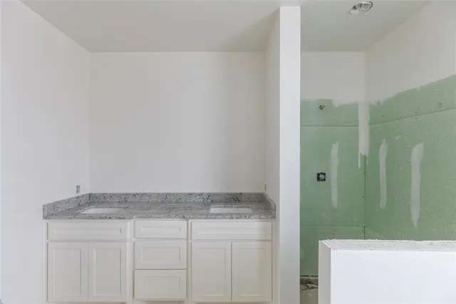 a grey house with a wooden fence