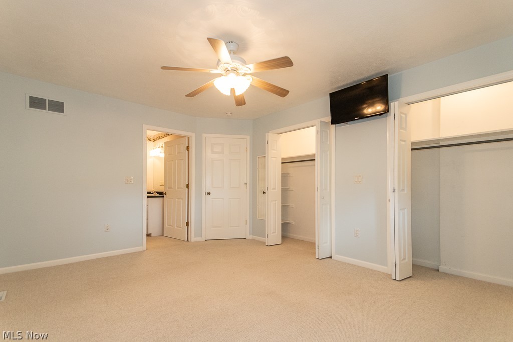 7710 Brakeman Road Painesville, OH 44077 - Photo 11 of 34 Unfurnished bedroom with light carpet and ceiling fan