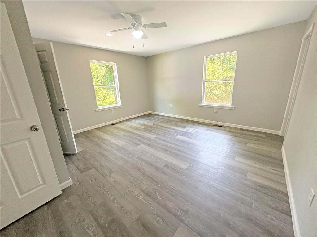 1231 Hillview Road Hampton, GA 30228 - Photo 21 of 49 a view of an empty room with a window and wooden floor