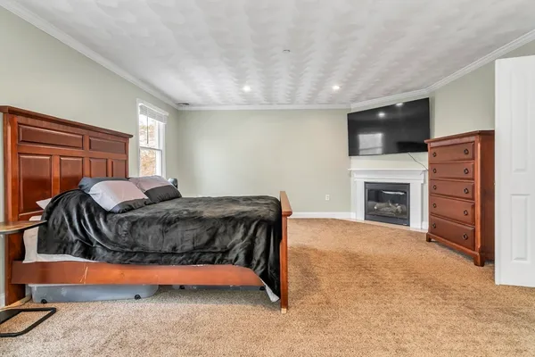 a bedroom with a bed and a large window