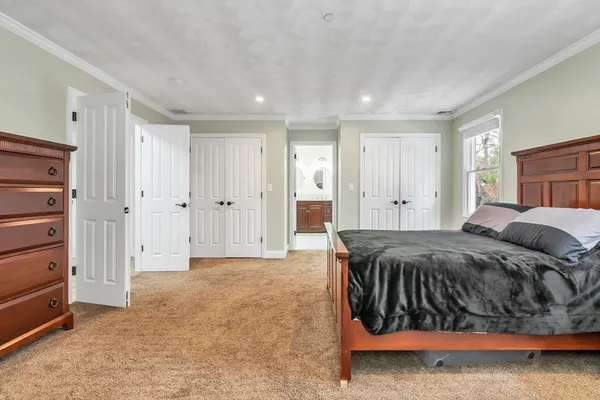 a bedroom with a bed and a desk