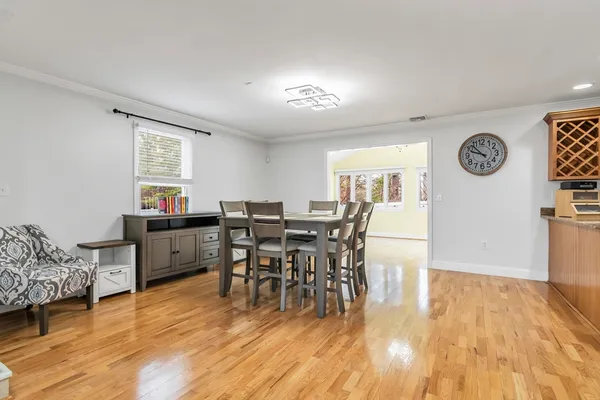 a view of a dining room with furniture and wooden floor