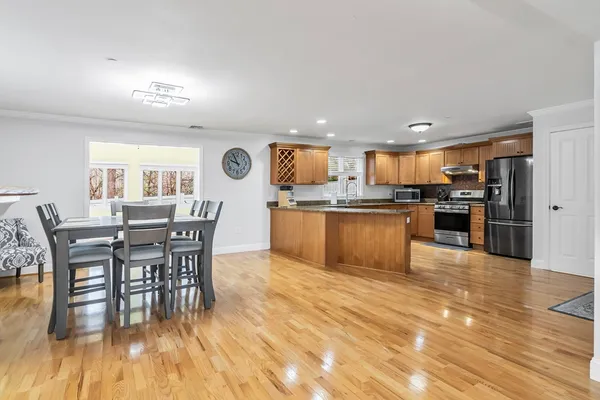 a large kitchen with stainless steel appliances granite countertop a stove a sink dishwasher and a refrigerator