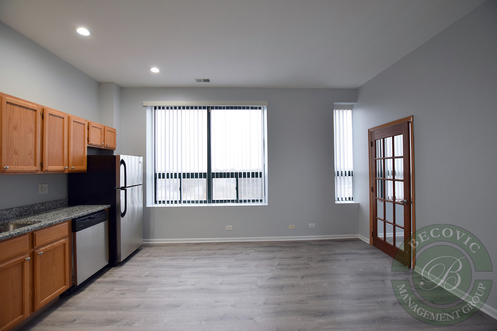2451 West Howard Street, Unit 601 Chicago, IL 60645 - Photo 4 of 6 a kitchen with granite countertop a stove a sink and a refrigerator
