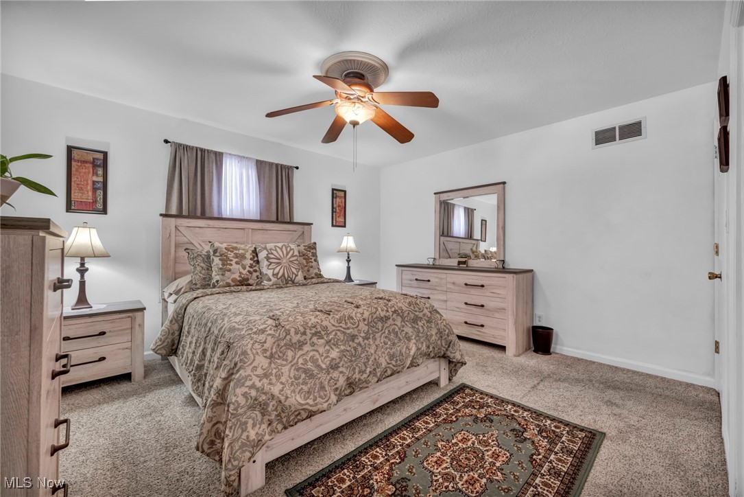 475 Harris Road Cleveland, OH 44143 - Photo 28 of 38 Carpeted bedroom with visible vents, baseboards, and a ceiling fan