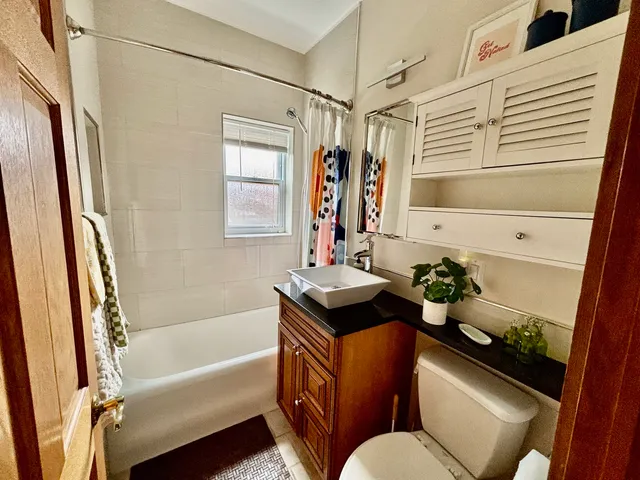 a view of a hallway with workspace and a window