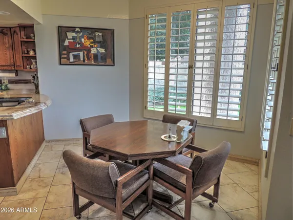 a kitchen with kitchen island granite countertop a sink a counter top space and stainless steel appliances