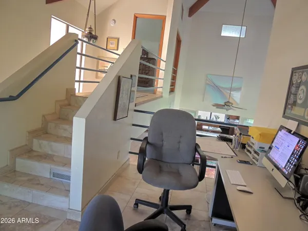 a room with furniture pool table and windows