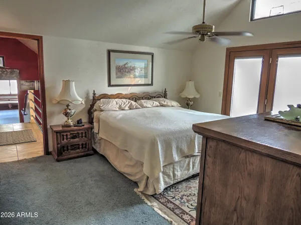a room with furniture pool table and window