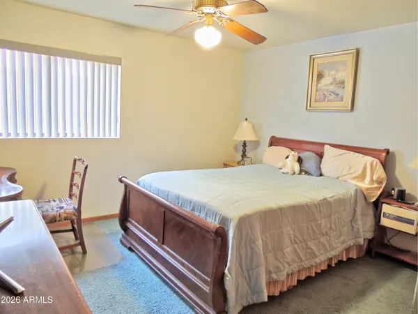a spacious bathroom with a granite countertop sink and a mirror