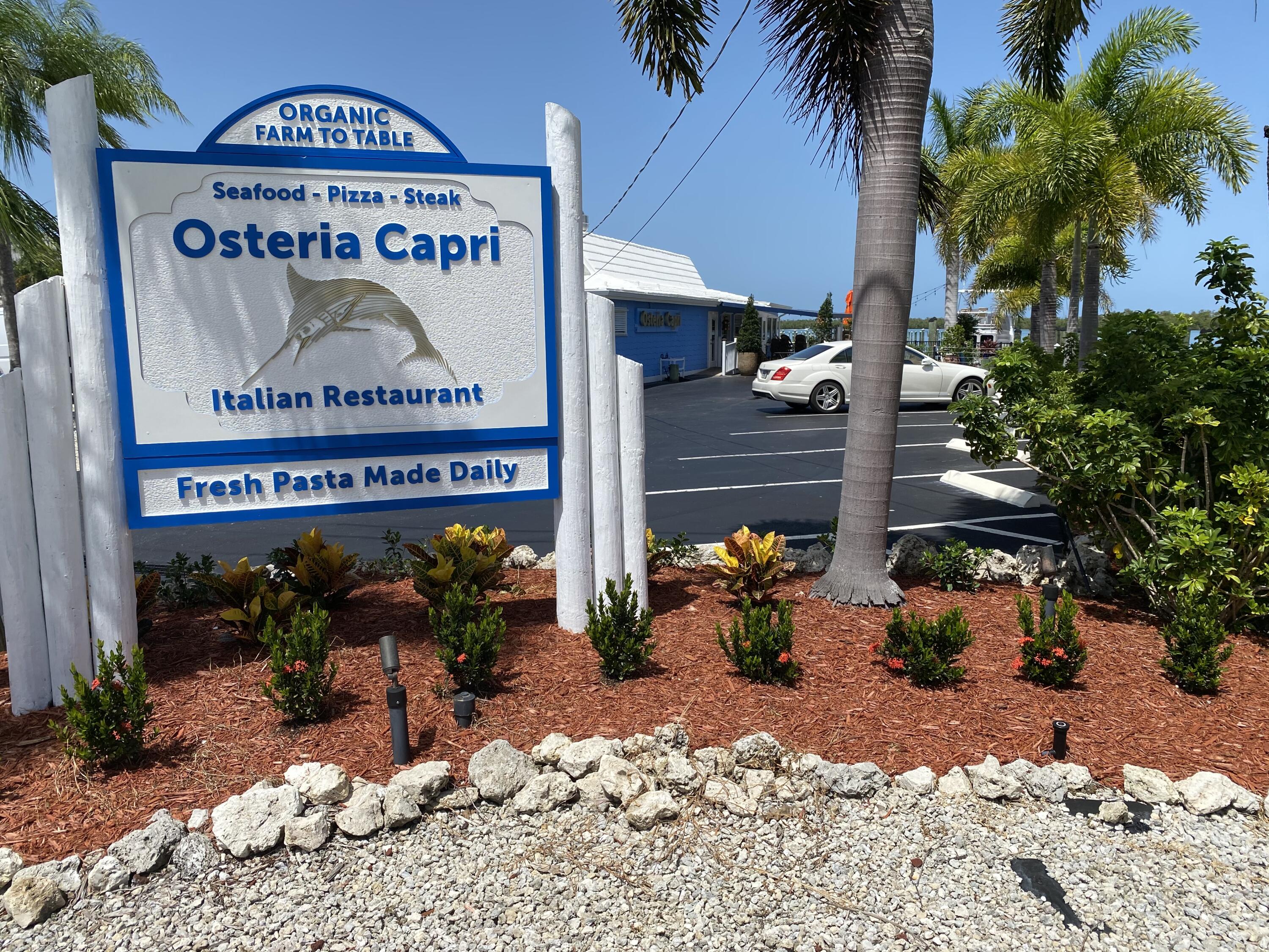 112 Capri Boulevard Naples, FL 34113 - Photo 28 of 29 a sign on the side of a building