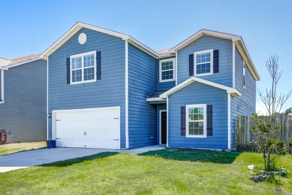 a front view of a house with a yard