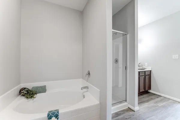 a white bath tub sitting next to a white sink