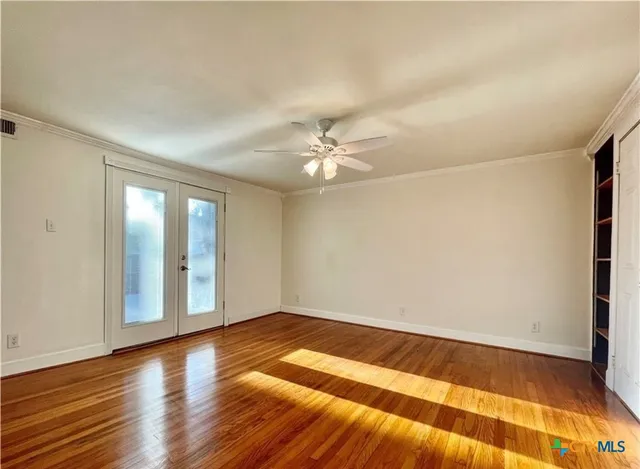 wooden floor in an empty room with a window