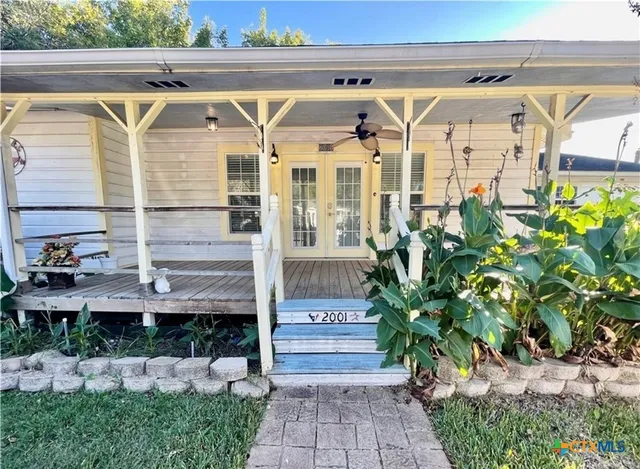 a view of front door and potted plants