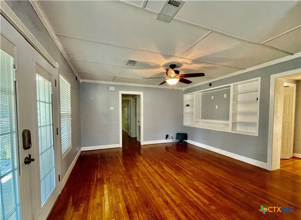 2001 East Forrest Street Victoria, TX 77901 - Photo 4 of 16 a view of an empty room with wooden floor and a window