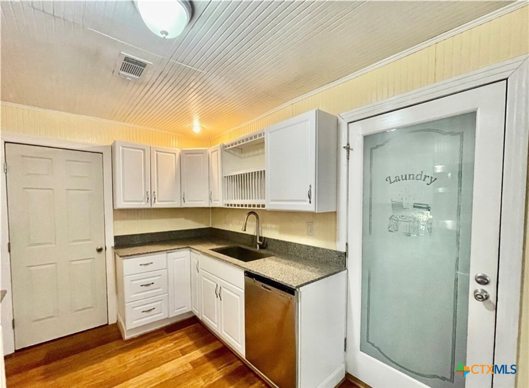 2001 East Forrest Street Victoria, TX 77901 - Photo 6 of 16 a kitchen with stainless steel appliances granite countertop a sink and cabinets with wooden floor