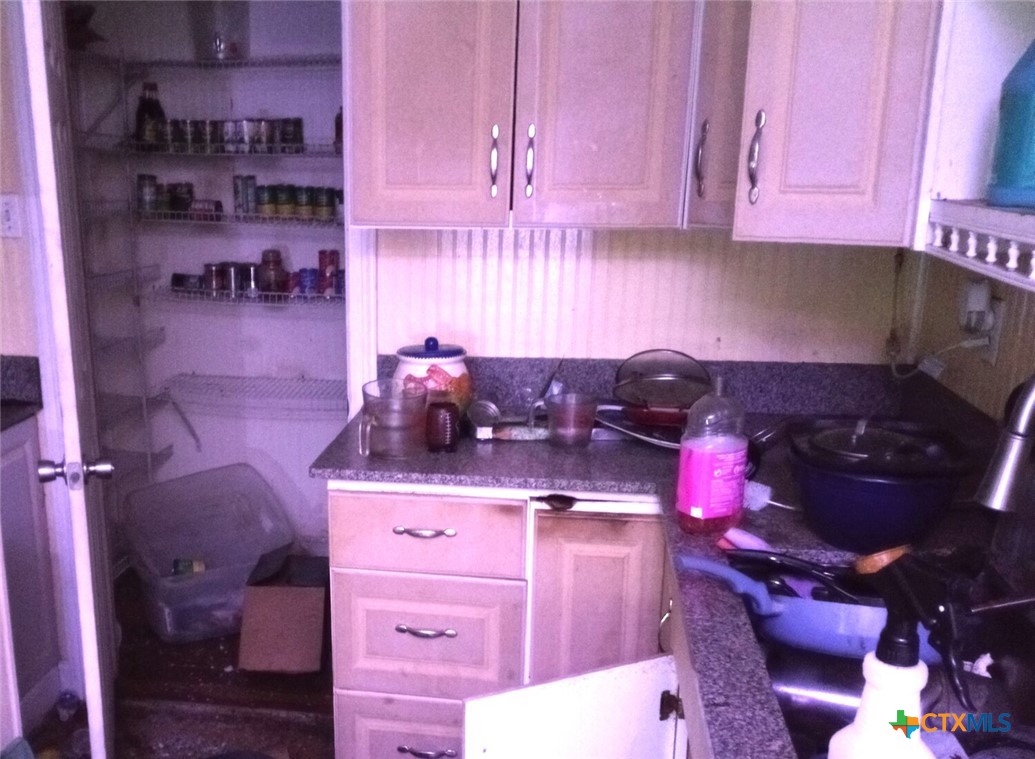2001 East Forrest Street Victoria, TX 77901 - Photo 8 of 16 a kitchen with granite countertop a stove and cabinets