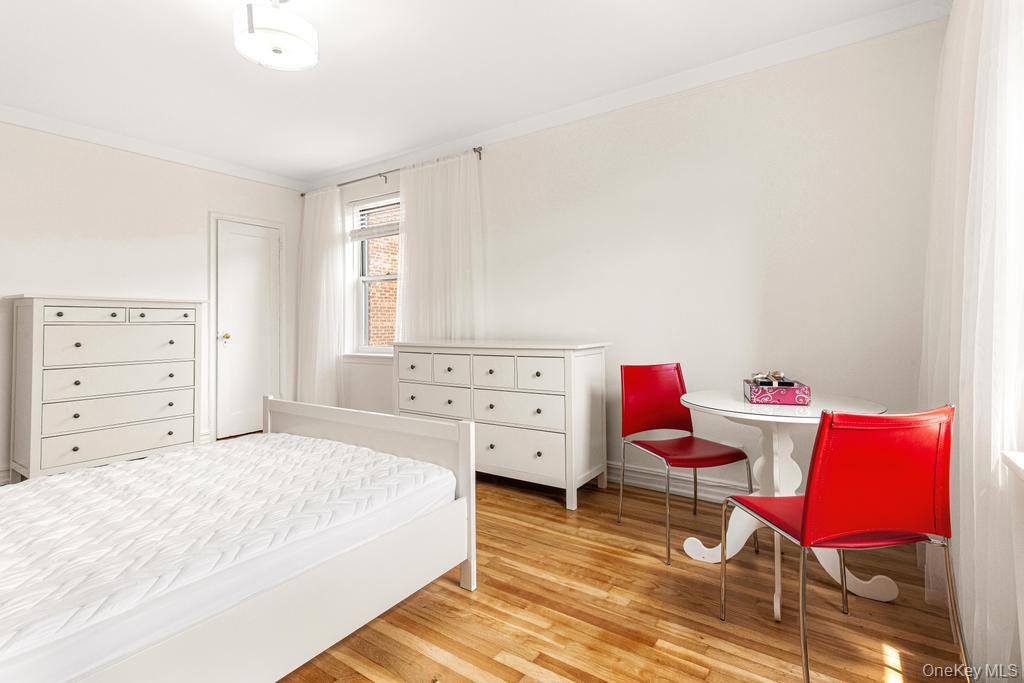 100-10 67th Road, Unit 6L Queens, NY 11375 - Photo 22 of 26 a bedroom with a bed and furniture