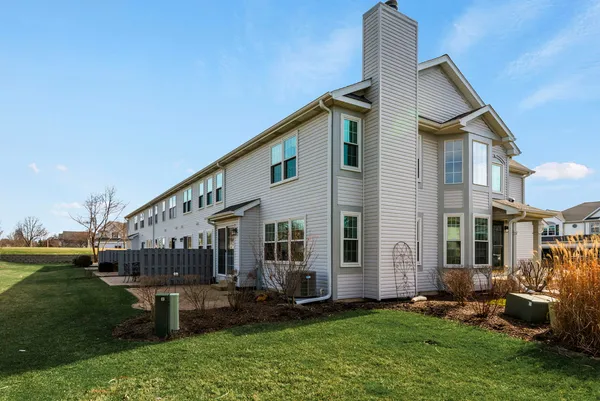 a backyard of a house with a garden and barbeque oven
