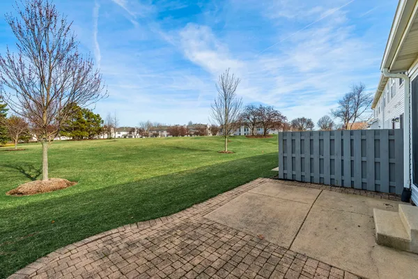 a view of a garden with wooden fence