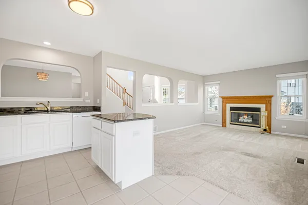 a kitchen with granite countertop a stove and a sink