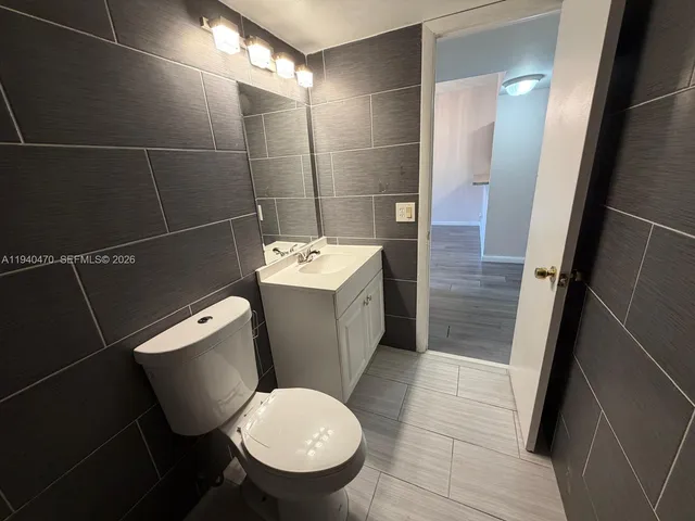a bathroom with a sink toilet and a mirror