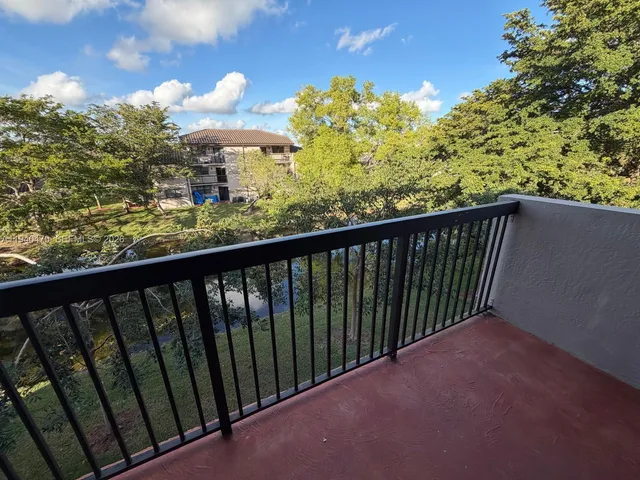 a view of a house with swimming pool and sitting area